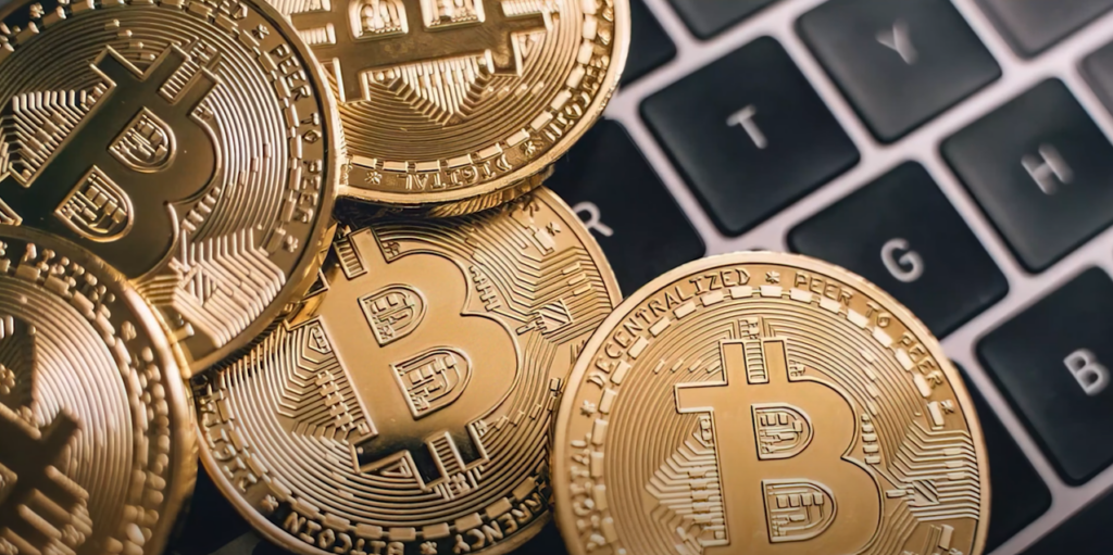 Golden coins resting on a laptop keyboard